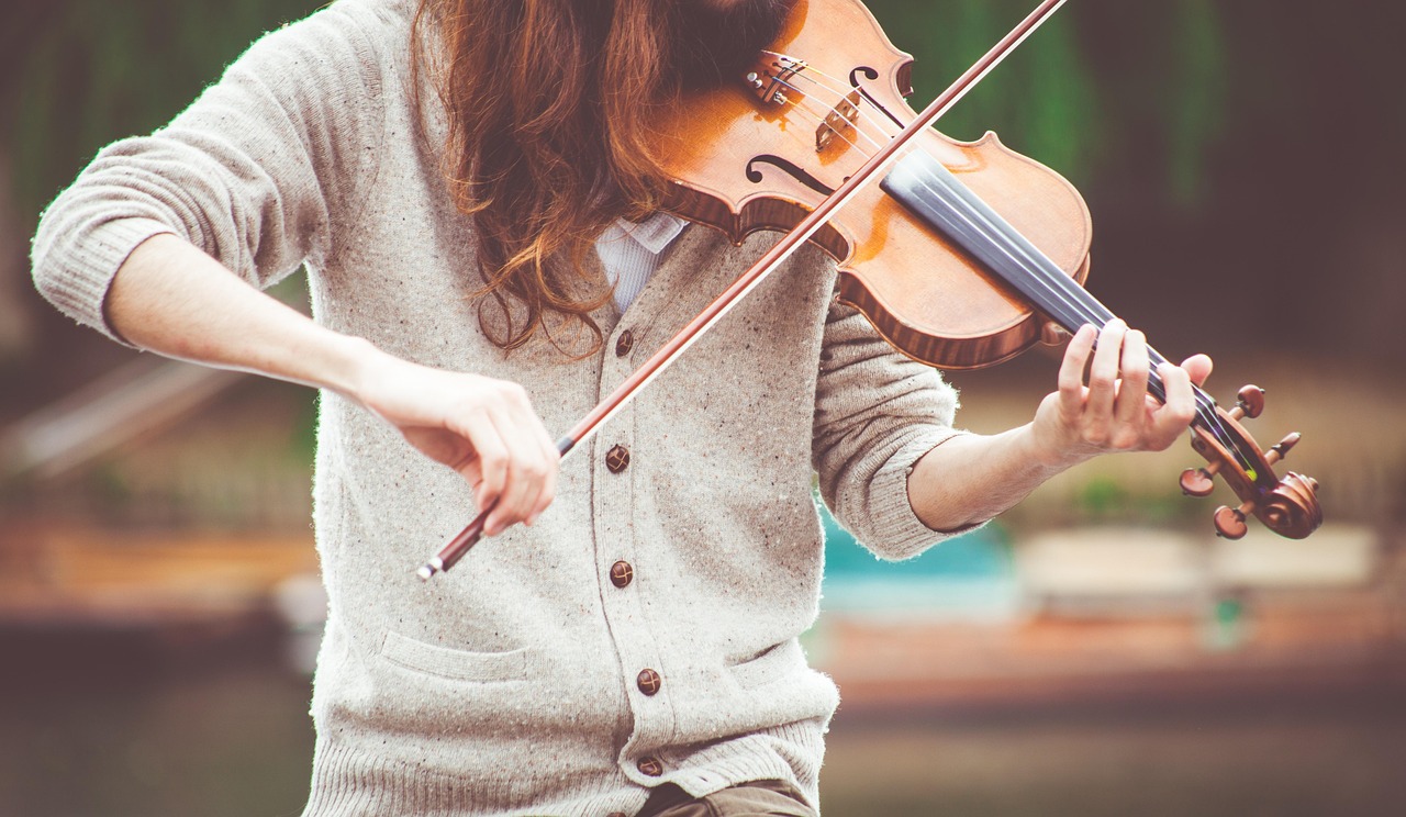A violin and bow resting on a surface